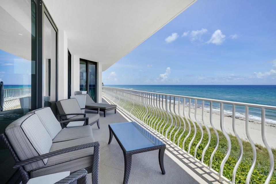 The wraparound balcony captures direct beachfront vistas and is accessed from several of the rooms.