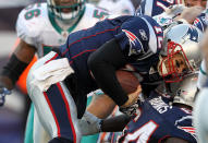 Tom Brady #12 of the New England Patriots scores the first of two touchdowns on the keeper against the Miami Dolphins in the second half at Gillette Stadium on December 24, 2011 in Foxboro, Massachusetts. (Photo by Jim Rogash/Getty Images)