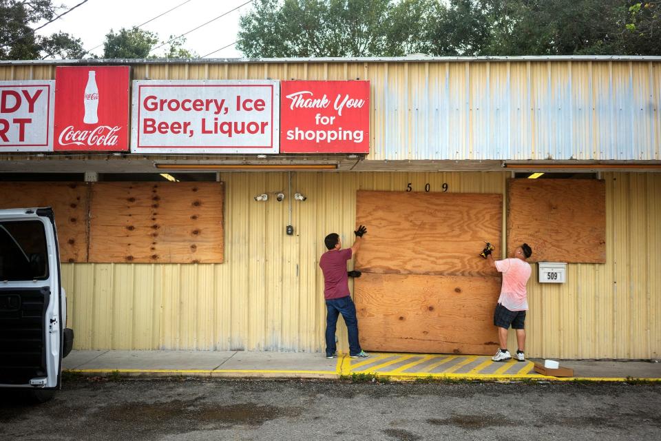 Image: Duy Dang helps his uncle Bang Bui board up his business Handy Mart as Hurricane Delta approaches in Abbeville, Louisiana. (Kathleen Flynn / Reuters)