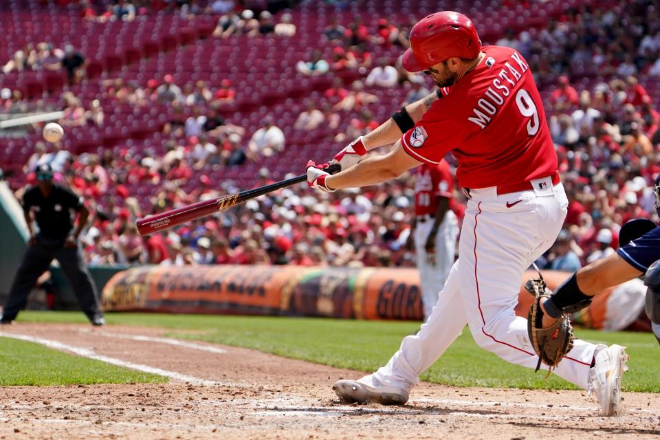 Cincinnati Reds first baseman Mike Moustakas (9) hits a three-run home during the third inning of a baseball game against the Tampa Bay Rays, Sunday, July 10, 2022, at Great American Ball Park in Cincinnati. The home run marked the 200th of his career.