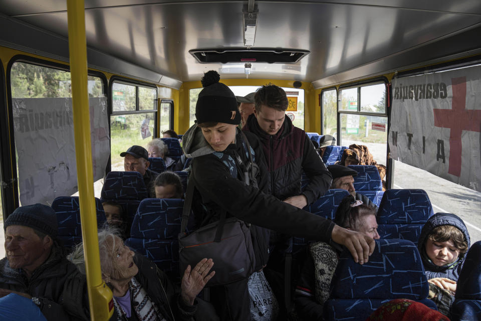 People ride in the bus during evacuation near Lyman, Ukraine, Wednesday, May 11, 2022. (AP Photo/Evgeniy Maloletka)