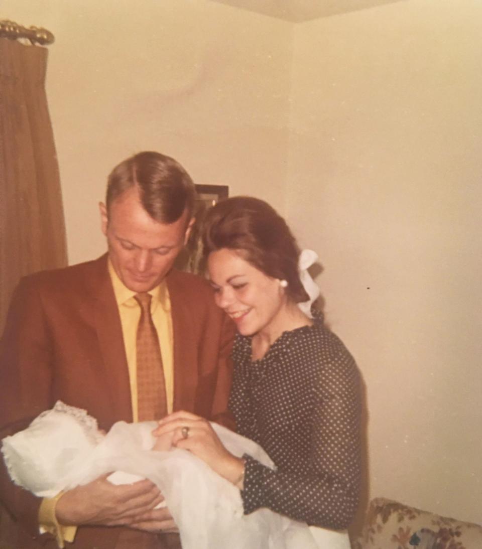 The author, in a christening gown, with his parents in 1970.