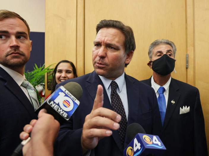 Florida Gov. Ron DeSantis responds to a local TV reporter's question after he signed legislation to make it harder for social media companies to punish users who violate terms of service agreements, on Monday, May 24, 2021, inside FIU MARC building in Miami, Florida.