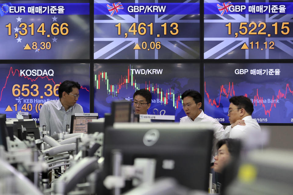 Currency traders work at the foreign exchange dealing room of the KEB Hana Bank headquarters in Seoul, South Korea, Thursday, Oct. 17, 2019. Asian shares were mixed Thursday after officials signaled work remains to be done on an agreement for a truce in the tariff war between the U.S. and China. (AP Photo/Ahn Young-joon)