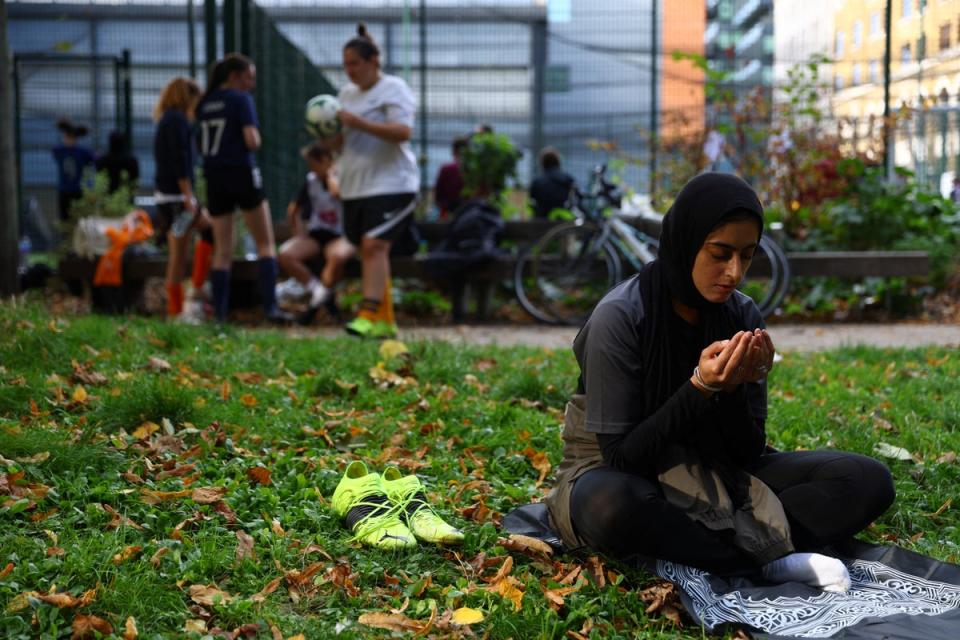 Fatima Ali, 26, prays between matches during the Ladies Super Liga 5-a-side tournament at The Colombo Centre (Reuters)