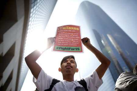 People protest for a $15-an-hour nationwide minimum wage in Los Angeles, California, United States, April 14, 2016. REUTERS/Lucy Nicholson