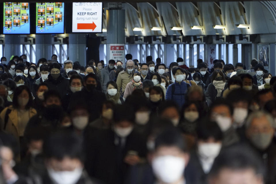 A station passageway is crowded with commuters wearing face mask during a rush hour Friday, Jan. 8, 2021 in Tokyo. Japanese Prime Minister Yoshihide Suga declared a state of emergency Thursday for Tokyo and three other prefectures to ramp up defenses against the spread of the coronavirus. (AP Photo/Eugene Hoshiko)