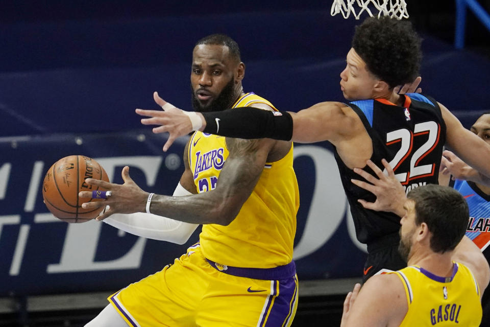 Los Angeles Lakers forward LeBron James, left, moves around Oklahoma City Thunder forward Isaiah Roby (22) during the first half of an NBA basketball game Wednesday, Jan. 13, 2021, in Oklahoma City. (AP Photo/Sue Ogrocki)