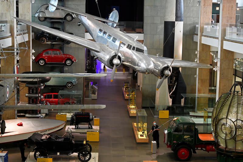 Employees clean exhibits ahead of the reopening of the Science Museum, in London, Britain