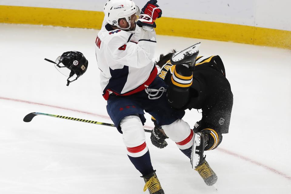 Washington Capitals' Alex Ovechkin, left, checks Boston Bruins' Brad Marchand during the third period in Game 4 of an NHL hockey Stanley Cup first-round playoff series Friday, May 21, 2021, in Boston. (AP Photo/Michael Dwyer)