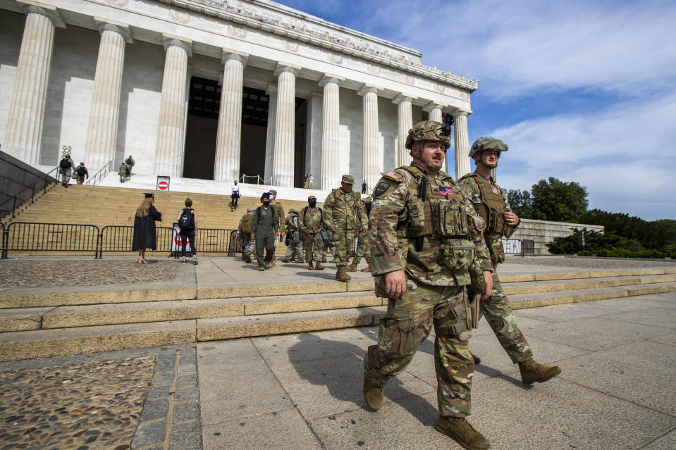 Members of the District of Columbia Army National Guard walk to their designated positions at the National Mall near the Lincoln Memorial in Washington, Wednesday, June 3, 2020, securing the area as protests continue following the death of George Floyd, a who died after being restrained by Minneapolis police officers. (AP Photo/Manuel Balce Ceneta)