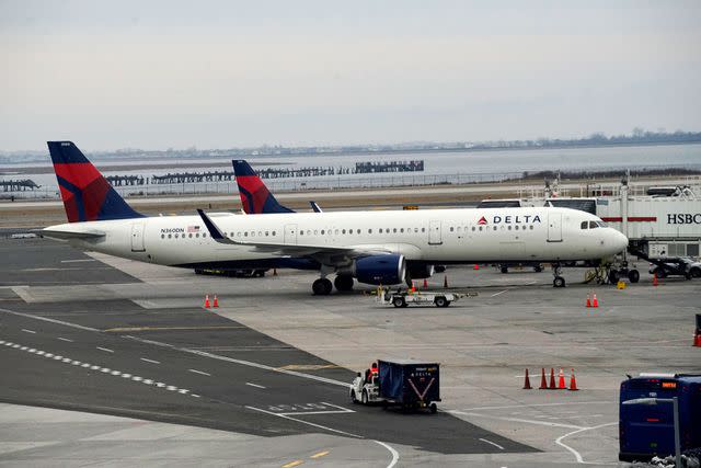 <p>Eduardo Munoz / VIEWpress via Getty</p> Delta plane at John F. Kennedy International Airport in New York City