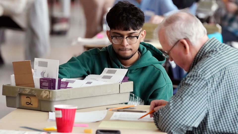 Election officials in Warren, Michigan, review absentee ballots on February 27, 2024. - Carlos Osorio/AP