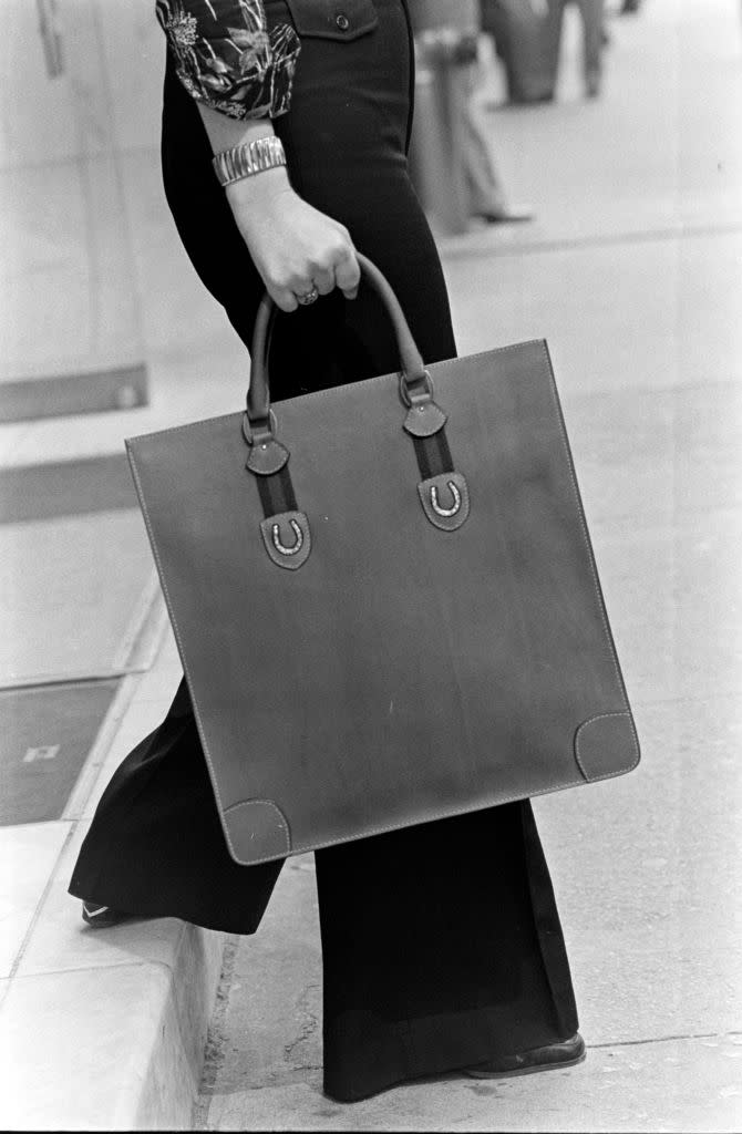 A model shows off the Gucci vintage web leather tote bag from the House of Gucci spring 1974 handbag collection.