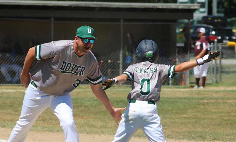 Dover Cal Ripken 11-year-old head coach Mike Lynch celebrates with Des Fennessy
during state tournament play last weekend in Swanzey. Dover will play Quintown on Thursday.