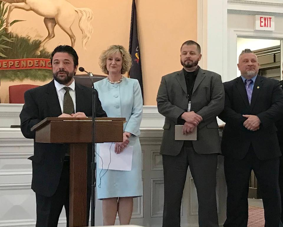 Mark Serge, left, chief deputy in the Pennsylvania Office of Attorney General, joins Erie County District Attorney Elizabeth Hirz and others in announcing on May 1, 2023, Erie County's inclusion in a statewide initiative aimed at aiding those seeking treatment for substance use disorder.