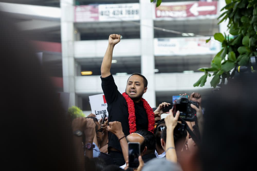 Farhash Wafa Salvador Rizal Mubarak gestures to the crowd as he leaves the Dang Wangi police station in Kuala Lumpur July 23, 2019. ― Picture by Ahmad Zamzahuri