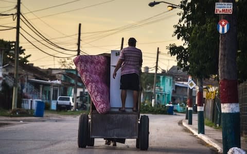 Cubans carry their belongings on September 7, 2017 to protect them from the arrival of Hurricane Irma, in Caibarien, Villa Clara  - Credit: ADALBERTO ROQUE/AFP