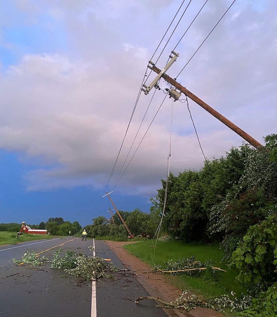 Damaged power poles are seen along Highway 22 west of Oconto on Thursday following the storm Wednesday night.