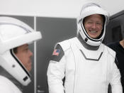 This Thursday, March 19, 2020 photo made available by SpaceX shows NASA astronauts Bob Behnken and Doug Hurley during flight simulator testing at the Kennedy Space Center in Cape Canaveral, Fla., with SpaceX teams in Firing Room 4 at NASA's Kennedy Space Center, SpaceX's Mission Control in Hawthorne, Calif., and NASA flight controllers in Mission Control Houston, for a full simulation of launch and docking of the Crew Dragon spacecraft. (SpaceX via AP)