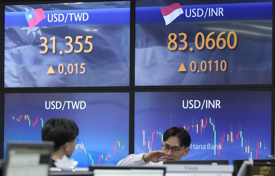 Currency traders work at the foreign exchange dealing room of the KEB Hana Bank headquarters in Seoul, South Korea, Tuesday, Jan. 23, 2024. Asian shares mostly rose Tuesday after Wall Street built on its all-time high reached last week, while Japan’s central bank kept its easy credit policy intact. (AP Photo/Ahn Young-joon)