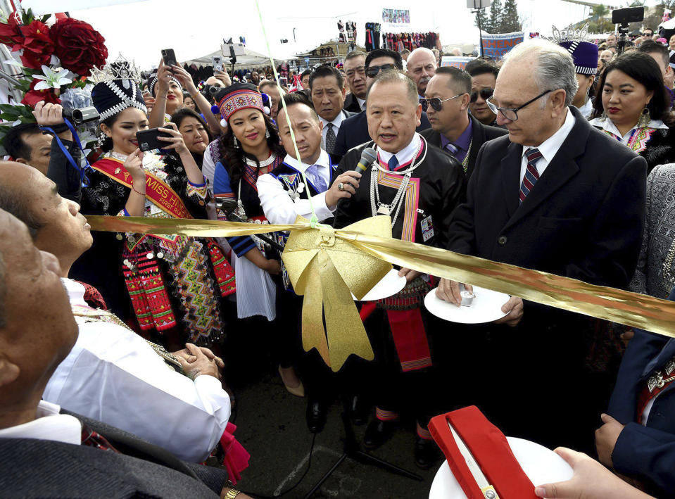 Fresno Mayor Lee Brand, right, joins with other dignitaries in dedication ceremonies kicking off the first day of the Hmong New Year celebration at the Fresno Fairgrounds, Thursday Dec. 26, 2019. (John Walker/The Fresno Bee via AP)