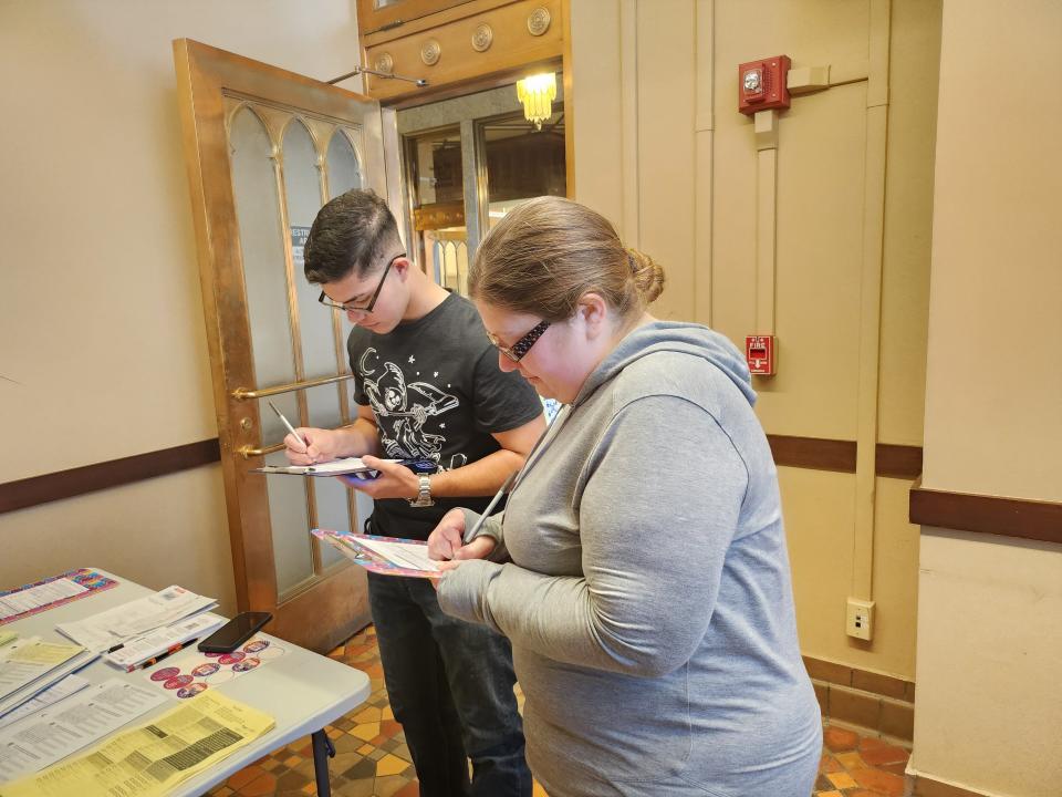 Amanda Guerra, right, and Andrew Guerra register to vote, with the help of the Amarillo League of Women Voters, before registration closes Thursday afternoon at the Potter County Elections Office.