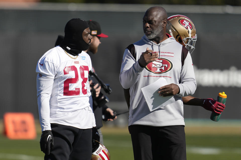 San Francisco 49ers running back Tevin Coleman (28) talks with ssistant head coach/running backs coach Anthony Lynn during an NFL football practice in Santa Clara, Calif., Thursday, Jan. 26, 2023. The 49ers are scheduled to play the Philadelphia Eagles Sunday in the NFC championship game. (AP Photo/Jeff Chiu)