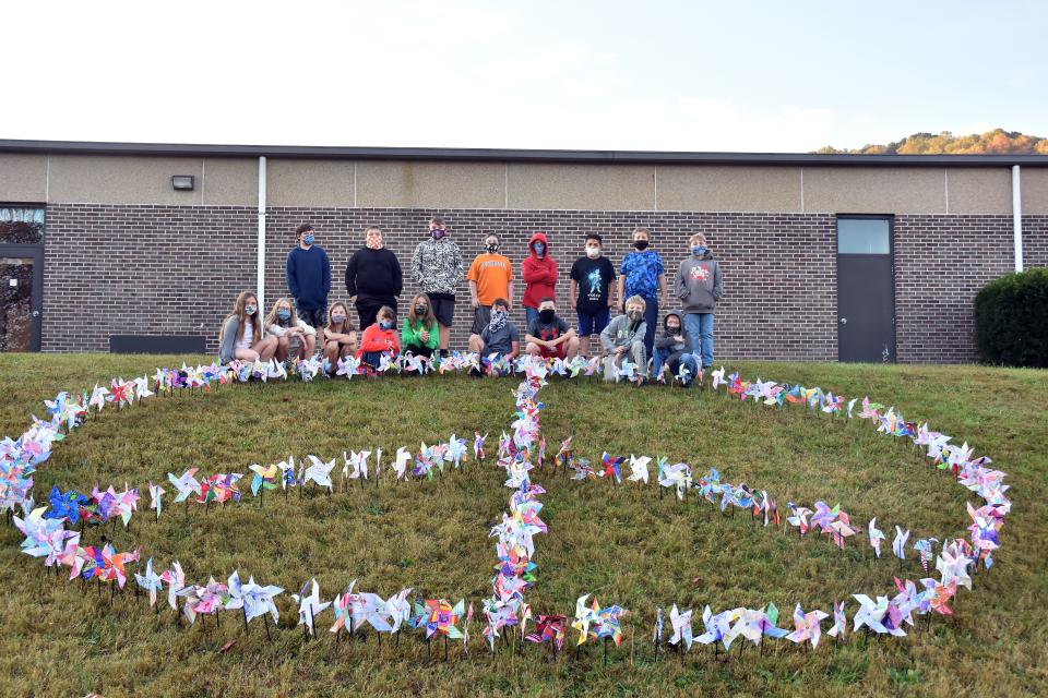 Elementary school students created this large pinwheel peace sign on the grounds of their school as part of a project for the International Day of Peace.