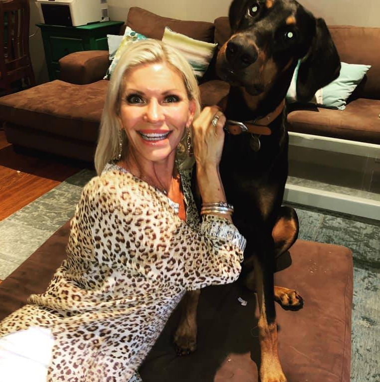 The NSW Central Coast woman is pictured with her Doberman, Harvey, in a Facebook photo.