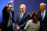 U.S. Secretary of Defense James Mattis (2nd L) is stopped by U.S. Director of National Intelligence Dan Coats (R) during the afternoon ministerial plenary for the Global Coalition working to Defeat ISIS at the State Department in Washington, U.S., March 22, 2017. REUTERS/Joshua Roberts