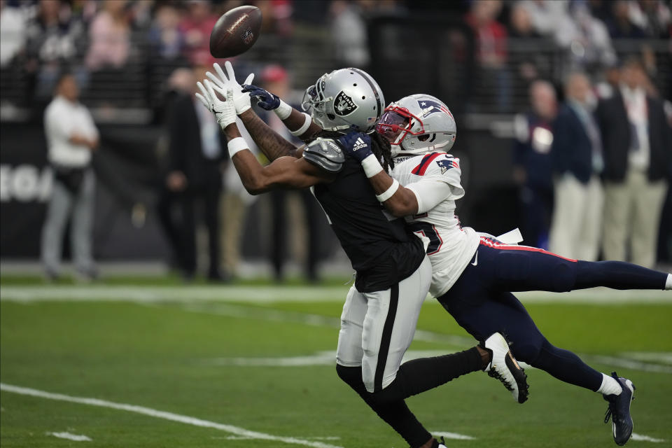 New England Patriots cornerback Marcus Jones (25) breaks up a pass intended for Las Vegas Raiders wide receiver Davante Adams during the first half of an NFL football game between the New England Patriots and Las Vegas Raiders, Sunday, Dec. 18, 2022, in Las Vegas. (AP Photo/John Locher)
