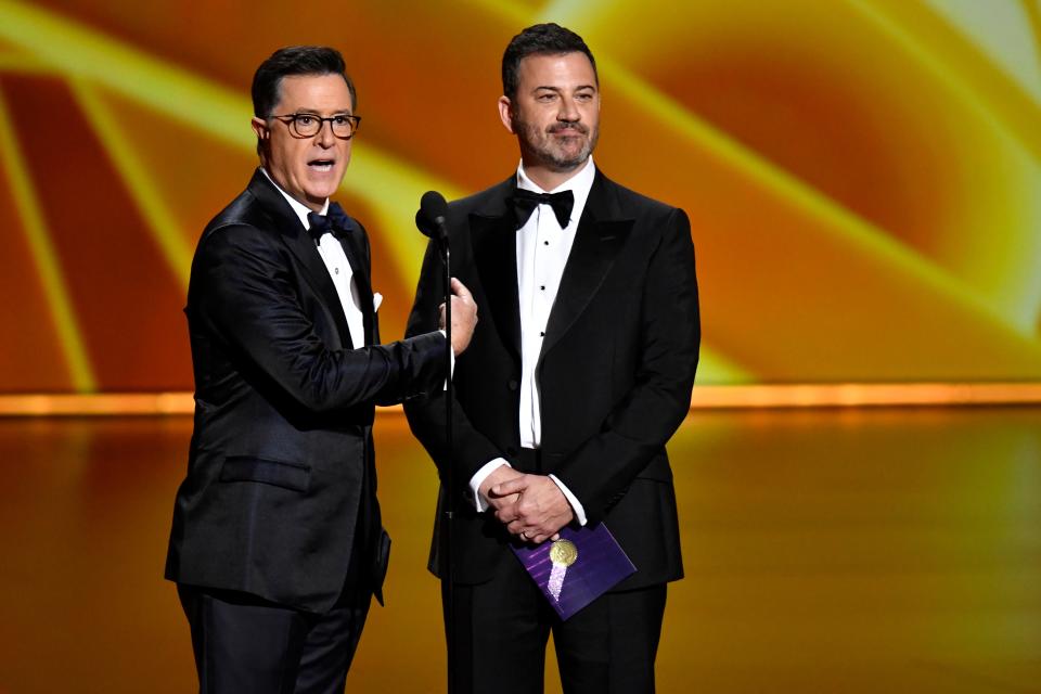 Stephen Colbert (L) and Jimmy Kimmel present the award for lead actress in a comedy series during the 71st Emmy Awards in 2019.