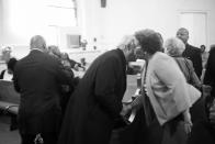 <p>Spencer Leak greets membres of a family at a funeral he helped organize on Chicago’s south side. (Photo: Jon Lowenstein/NOOR for Yahoo News) </p>