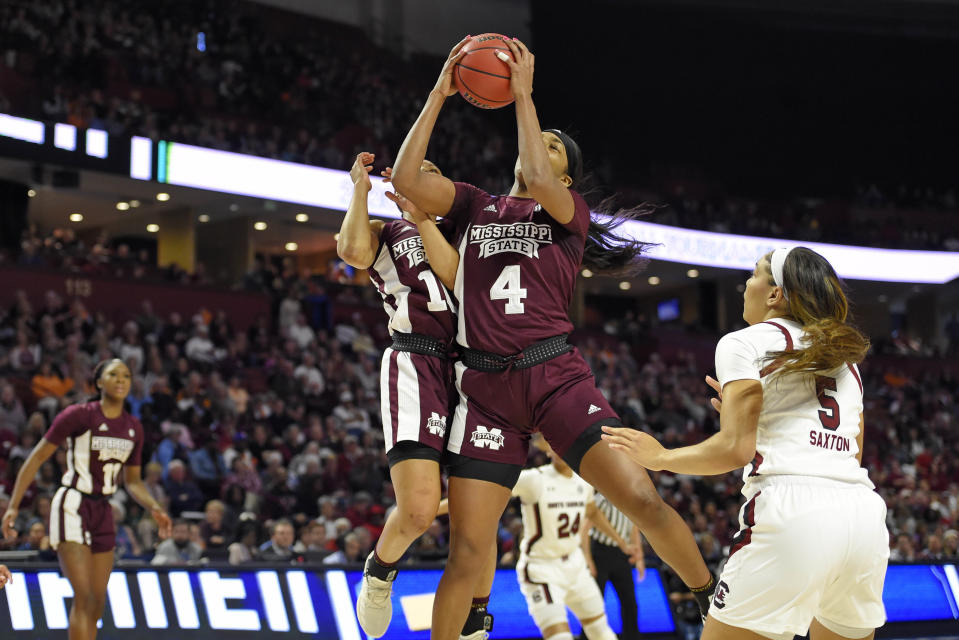 Mississippi State's Jessika Carter (4) and JaMya Mingo-Young, back, retrieve a rebound while defended by South Carolina's Victaria Saxton (5) during a championship match at the Southeastern Conference women's NCAA college basketball tournament in Greenville, S.C., Sunday, March 8, 2020. (AP Photo/Richard Shiro)