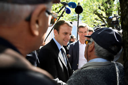 Emmanuel Macron, head of the political movement En Marche ! ( Onwards !) and candidate for the 2017 presidential election, talks with residents during a campaign visit in Bagneres de Bigorre, France, April 12, 2017. REUTERS/Eric Feferberg/Pool