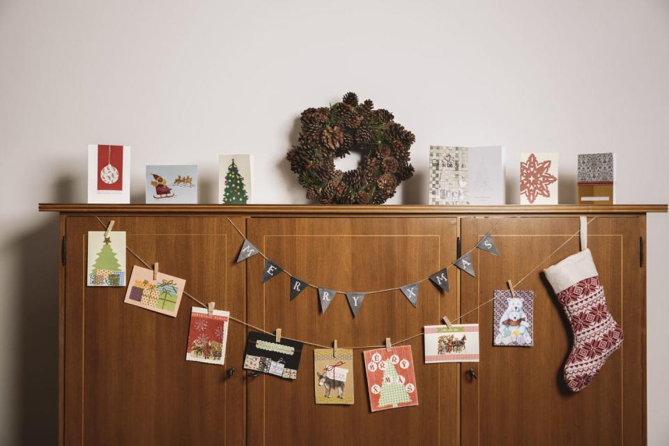 <p>Don't just toss all of those adorable family Christmas cards into a basket somewhere—they deserve some daily attention. String some twine across a side table or along your stairway, then use clothespins to hang each special greeting. </p><p><a class="link " href="https://www.amazon.com/Boao-Christmas-Gloves-Snowflake-Clothespins/dp/B07V3KXD8Z/?tag=syn-yahoo-20&ascsubtag=%5Bartid%7C10072.g.34454588%5Bsrc%7Cyahoo-us" rel="nofollow noopener" target="_blank" data-ylk="slk:SHOP CHRISTMAS CLOTHESPINS;elm:context_link;itc:0;sec:content-canvas">SHOP CHRISTMAS CLOTHESPINS</a></p>