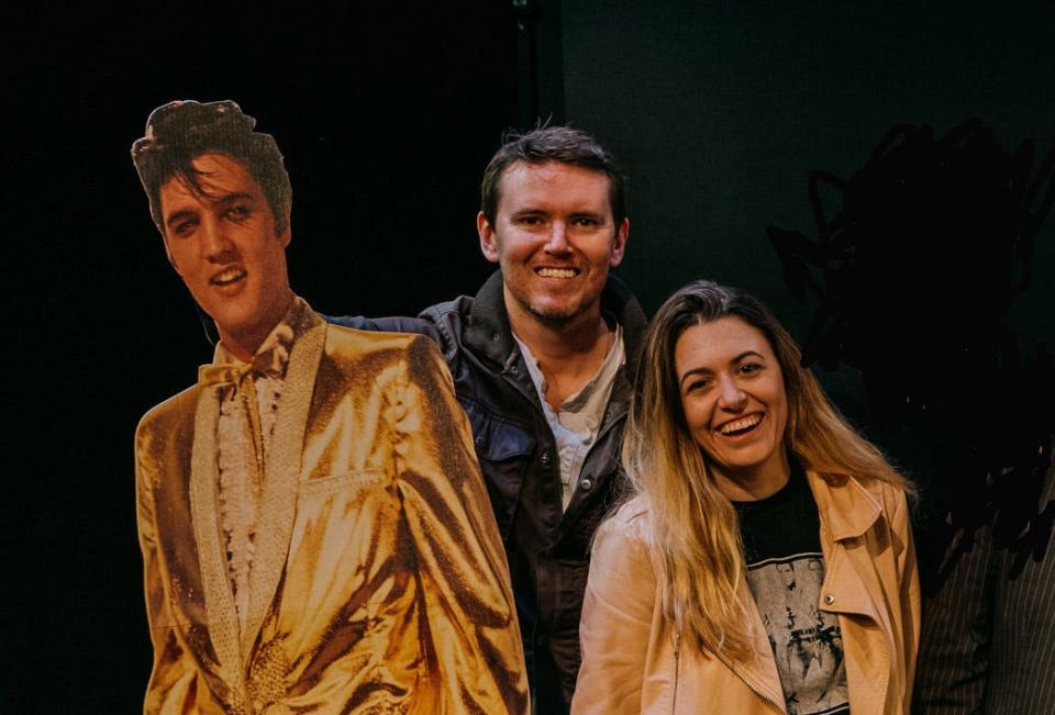 Matt Wood, composer of the original music for "Graceland Too: The Building Elvis Never Left," poses with the play's writer/producer, Nicole Hughes,  and a cardboard cutout of a friend during New York rehearsals.