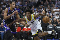 Sacramento Kings forward Keegan Murray (13) guards Utah Jazz guard Collin Sexton (2) during the first half of an NBA basketball game in Sacramento, Calif., Sunday, March 31, 2024. (AP Photo/Randall Benton)