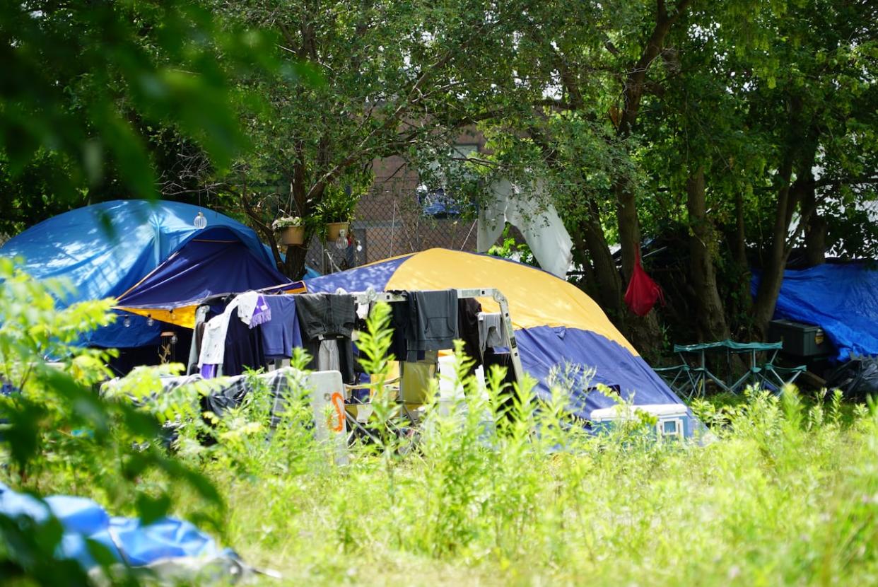 It was not immediately clear what led to the City of Canbridge withdrawing eviction notices to residents at the Branchton Road and Dundas Street encampment and a city spokesperson said they could not comment. (Carmen Groleau/CBC - image credit)