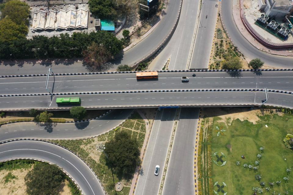 This aerial picture taken on March 22, 2020, shows deserted streets during a one-day nationwide Janata (civil) curfew imposed as a preventive measure against the COVID-19 coronavirus in New Delhi on March 22, 2020. - Nearly one billion people around the world were confined to their homes on March 22, as the coronavirus death toll crossed 13,000 and factories were shut in worst-hit Italy after another single-day fatalities record. (Photo by Prakash SINGH / AFP) (Photo by PRAKASH SINGH/AFP via Getty Images)