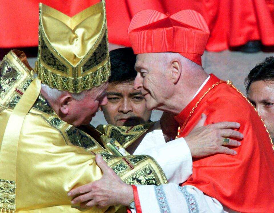 FILE - In this Feb. 21, 2001 file photo, Cardinal Theodore Edgar McCarrick, archbishop of Washington D.C., wearing the three-cornered biretta hat, embraces Pope John Paul II in St. Peter's Square at the Vatican. In a sunlit ceremony of ancient ritual in St. Peter's Square, Pope John Paul II installed a record number of cardinals - 44 new princes of the Roman Catholic Church. (AP Photo/Jerome Delay, File)