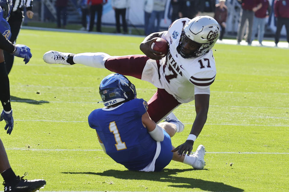 Montana quarterback Clifton McDowell (17) is tackled in the first half by South Dakota State safety Tucker Large (1) in the first half at the FCS Championship NCAA college football game Sunday, Jan. 7, 2024, in Frisco, Texas. (AP Photo/Richard W. Rodriguez)