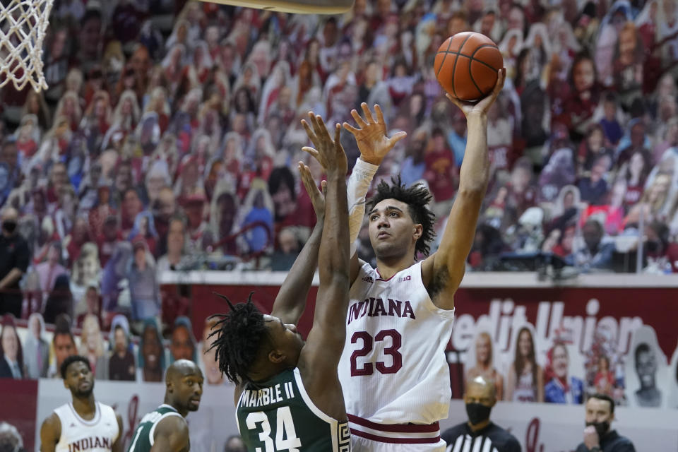 Indiana's Trayce Jackson-Davis (23) shoots over Michigan State's Julius Marble II (34) during the second half of an NCAA college basketball game, Saturday, Feb. 20, 2021, in Bloomington, Ind. Michigan State won 78-71. (AP Photo/Darron Cummings)