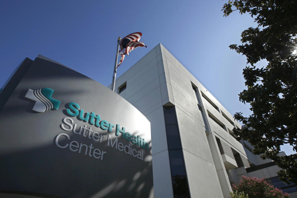 FILE - In this Sept. 20, 2019, file photo, an American flag flutters in the breeze outside of the Sutter Medical Center in Sacramento, Calif. Opening arguments begin Thursday, Oct. 10, 2019, in the antitrust case against Sutter Health, one of California's largest hospital systems, which is facing a trial over accusations that it has used its market dominance to snuff out competition and overcharge patients for medical bills. (AP Photo/Rich Pedroncelli, File)