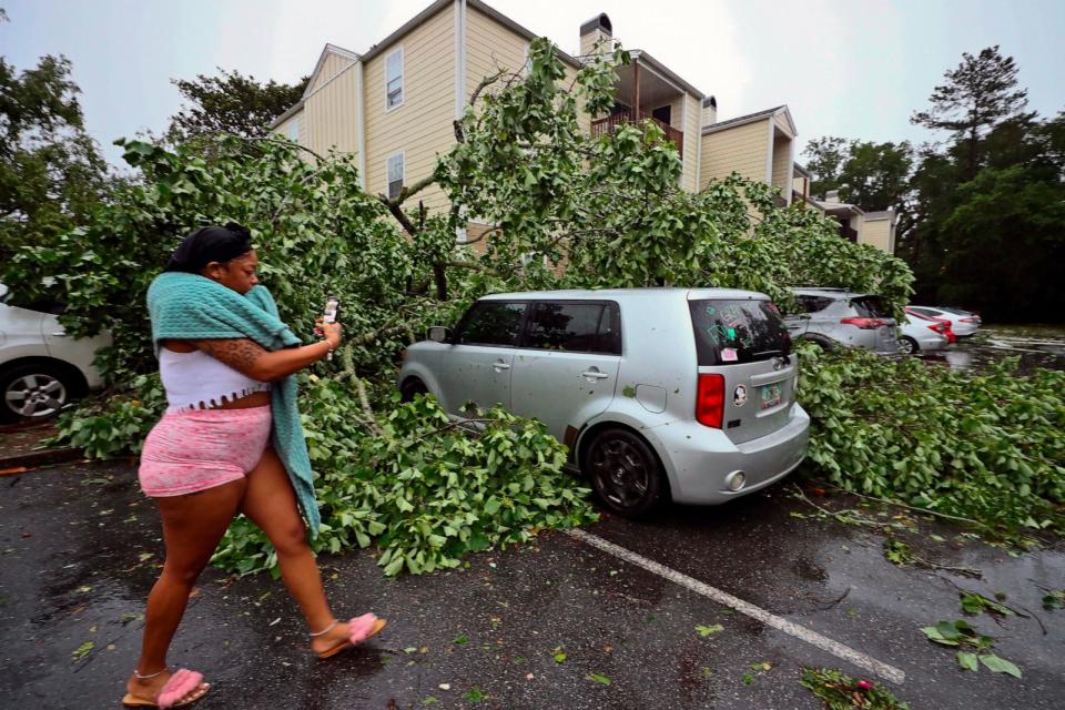 PHOTO: A resident records the damage to cars outside an apartment complex in Tallahassee, Fla., May 10, 2024. (Phil Sears/AP)