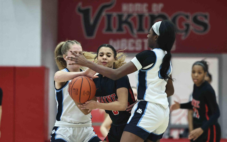Mount Notre Dame forward Laila Harrison (00) and Grace Pitzer (3) surround Wayne's Janaya Lenoir (3) during their district final Saturday, March 2, 2024.