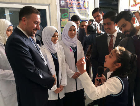 Khamis Khanjar, (2nd L) a Sunni multimillionaire, visits displaced Sunni Iraqis at a school he funds in Iraqi Kurdistan, Iraq, February 16, 2016. REUTERS/Ned Parker