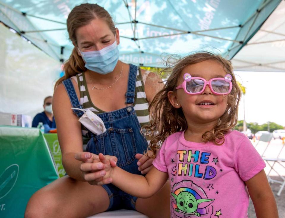 Westchester resident Julie Budejen, 35, watches as her daughter Zoey, 3, reacts after a healthcare worker administered a Pfizer shot at the Nomi Health Mobile Health Unit inside Tropical Park in Miami, Florida, on Saturday, June 25, 2022.