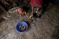 <p>Hagar Yahia pours tea for her 5-year-old daughter Awsaf in their hut in Abyan, Yemen in this Feb. 15, 2018 photo. Many families across southern Yemen described how they live largely on bread and sweetened tea, sometimes just once a day. (Photo: Nariman El-Mofty/AP) </p>